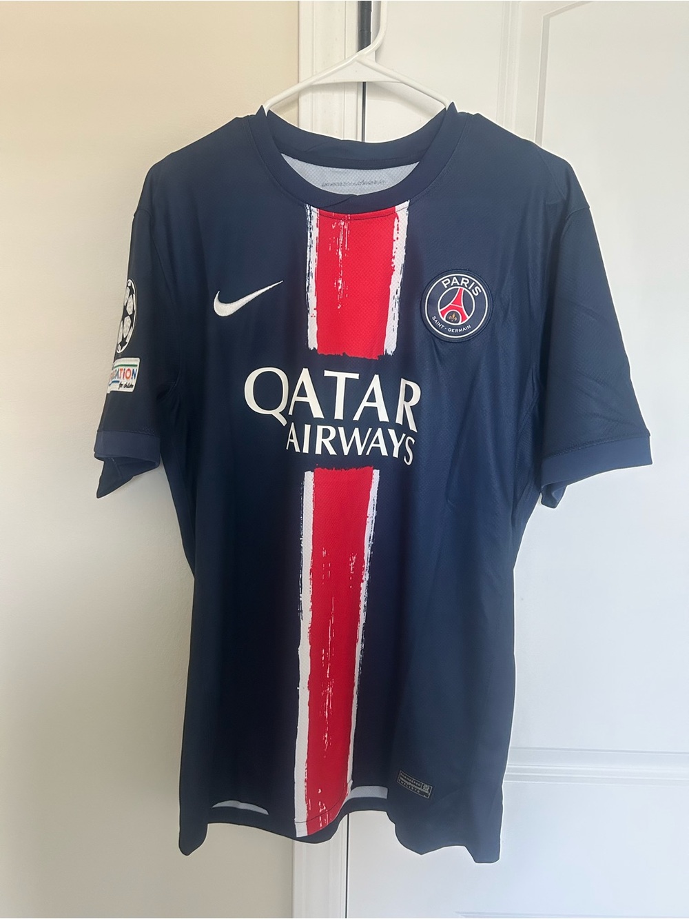 Nike PSG Men's Navy Soccer Jersey with Red and White Center Stripe